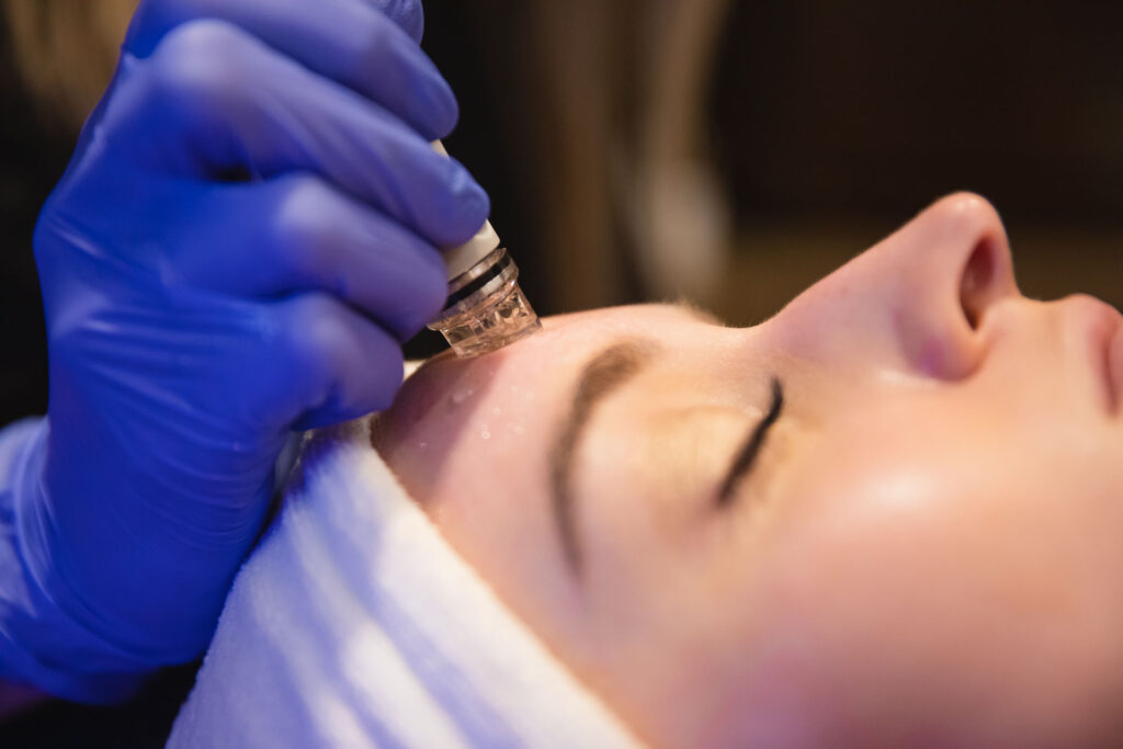 A patient receives a Hydrafacial as skin texture treatments in Denver, CO