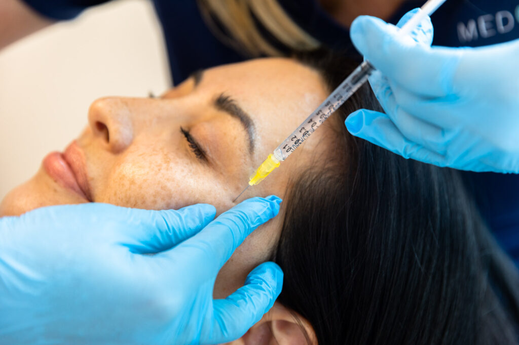 A woman receives a Botox injection after budgeting for medical aesthetics 